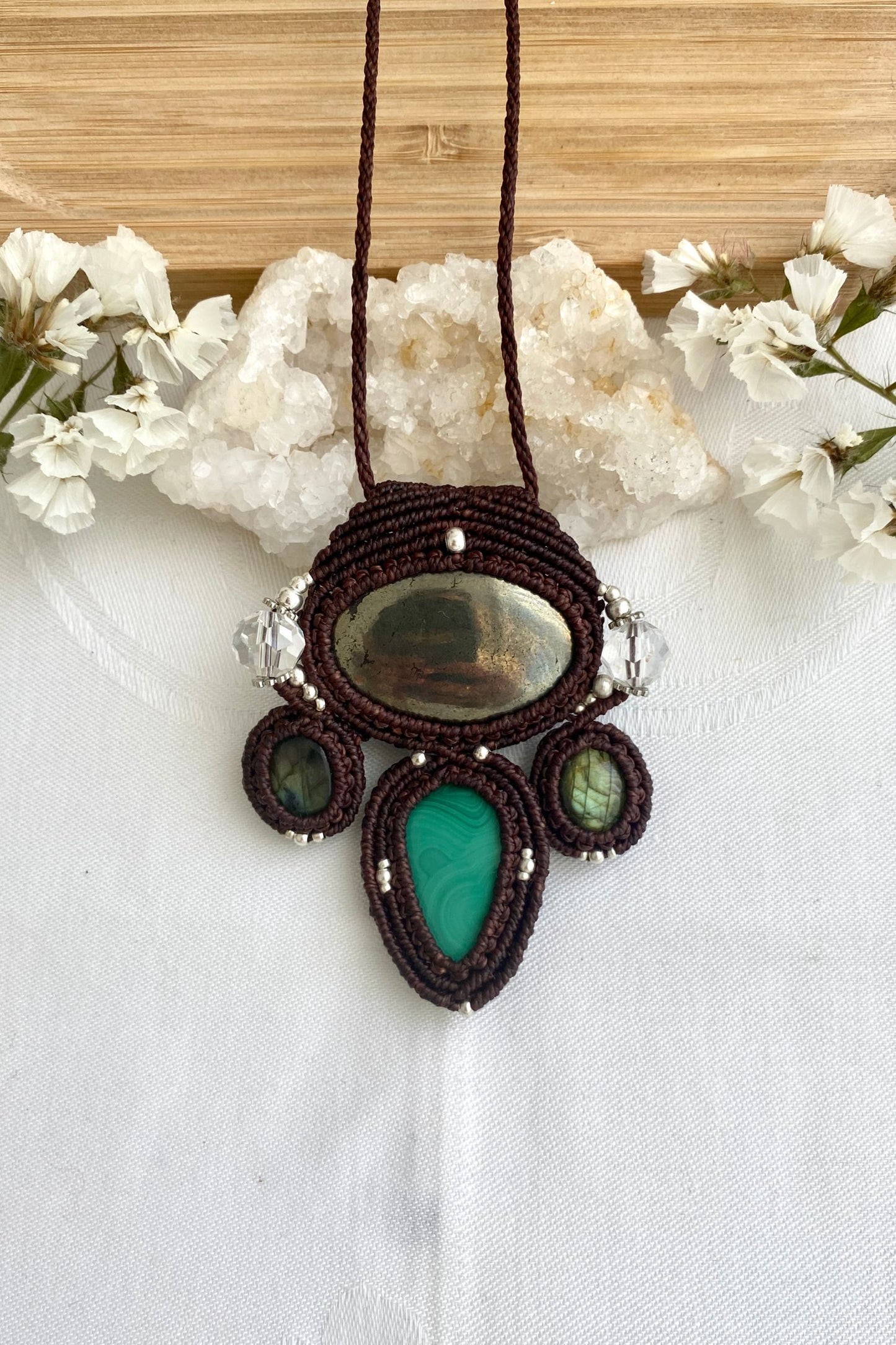 A close-up of the handmade gemstone necklace, showcasing the natural beauty of Pyrite, Labradorite, Malachite and Quartz in an exclusive, one-of-a-kind design.