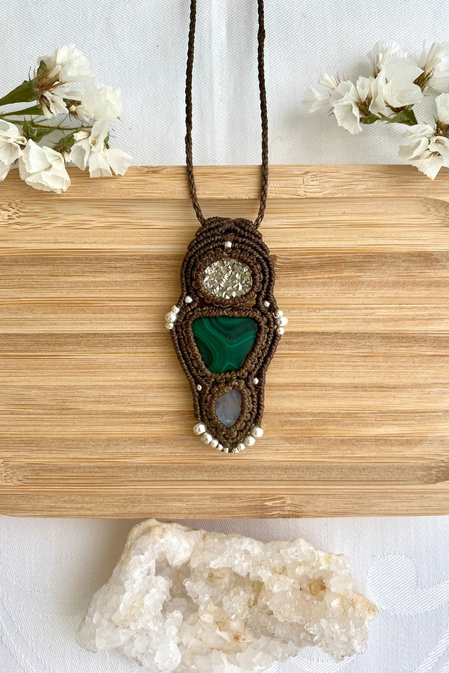 Handmade macrame necklace featuring Raw Pyrite, Malachite and Moonstone gemstones, crafted with a unique and artistic design, offering an adjustable length for a perfect fit.