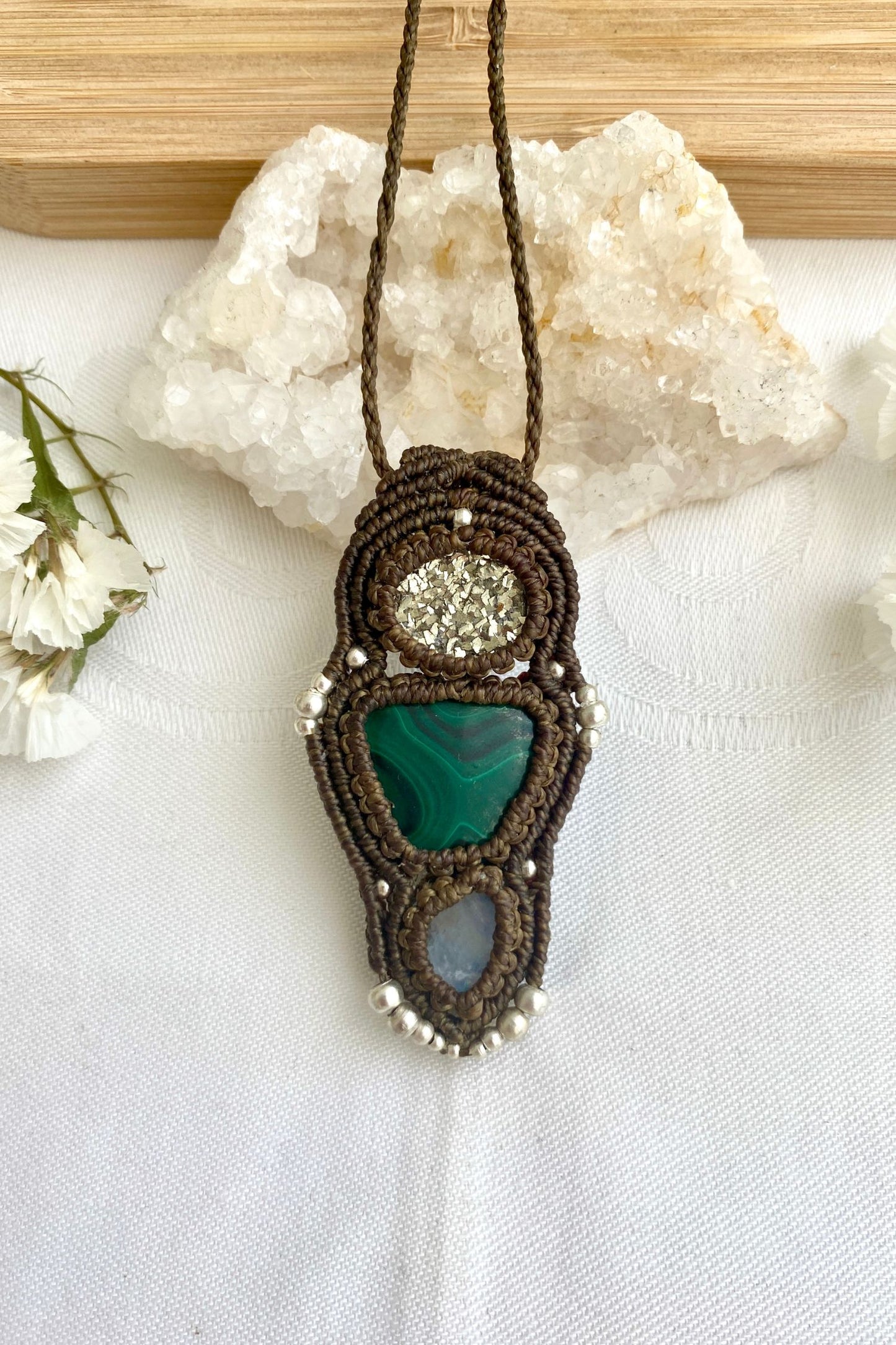A close-up of the handmade gemstone necklace, showcasing the natural beauty of Raw Pyrite, Malachite and Moonstone in an exclusive, one-of-a-kind design.