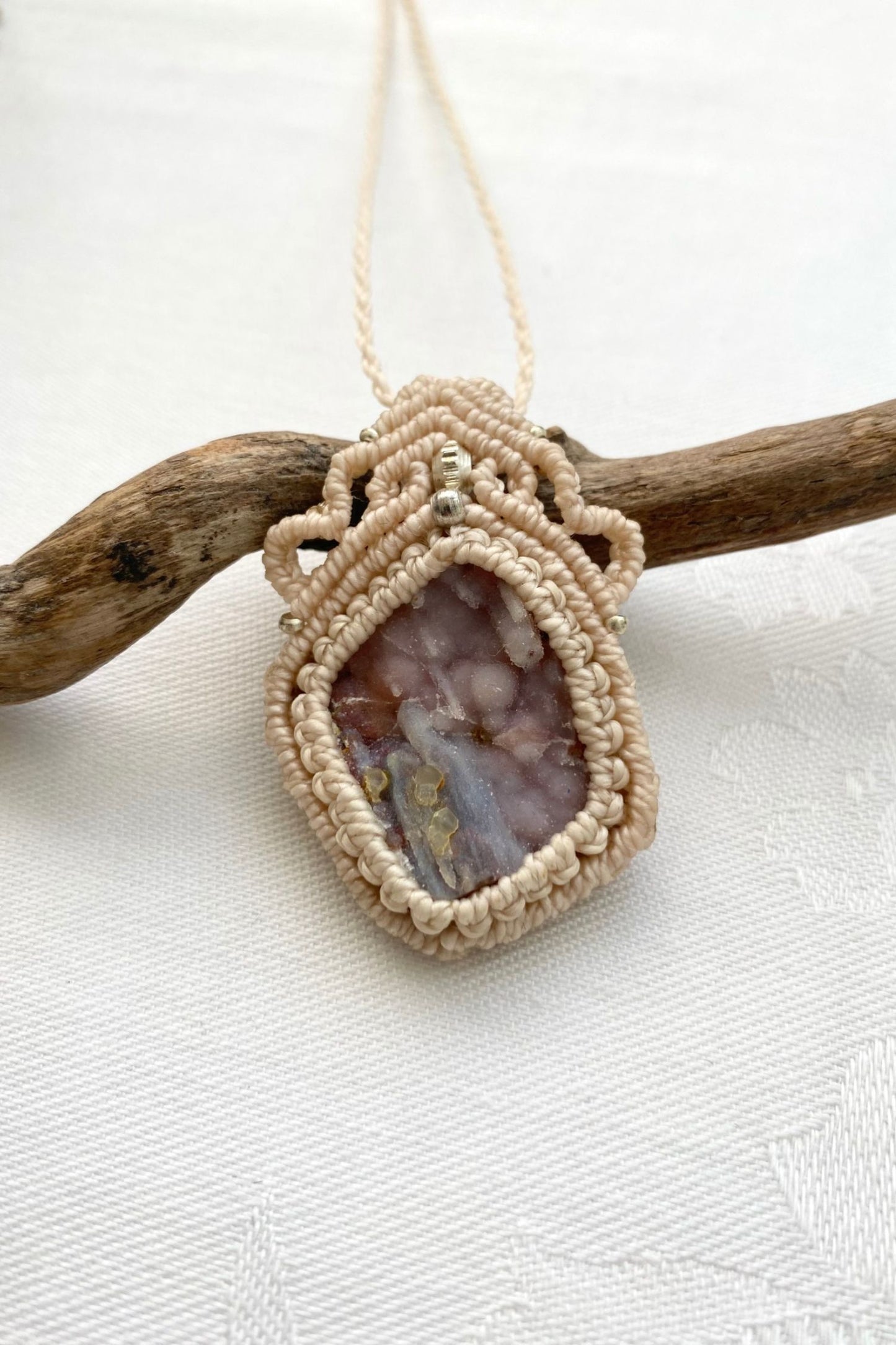 A close-up of the handmade gemstone necklace, showcasing the natural beauty of Raw Pink Chalcedony Stalactite in an exclusive, one-of-a-kind design.