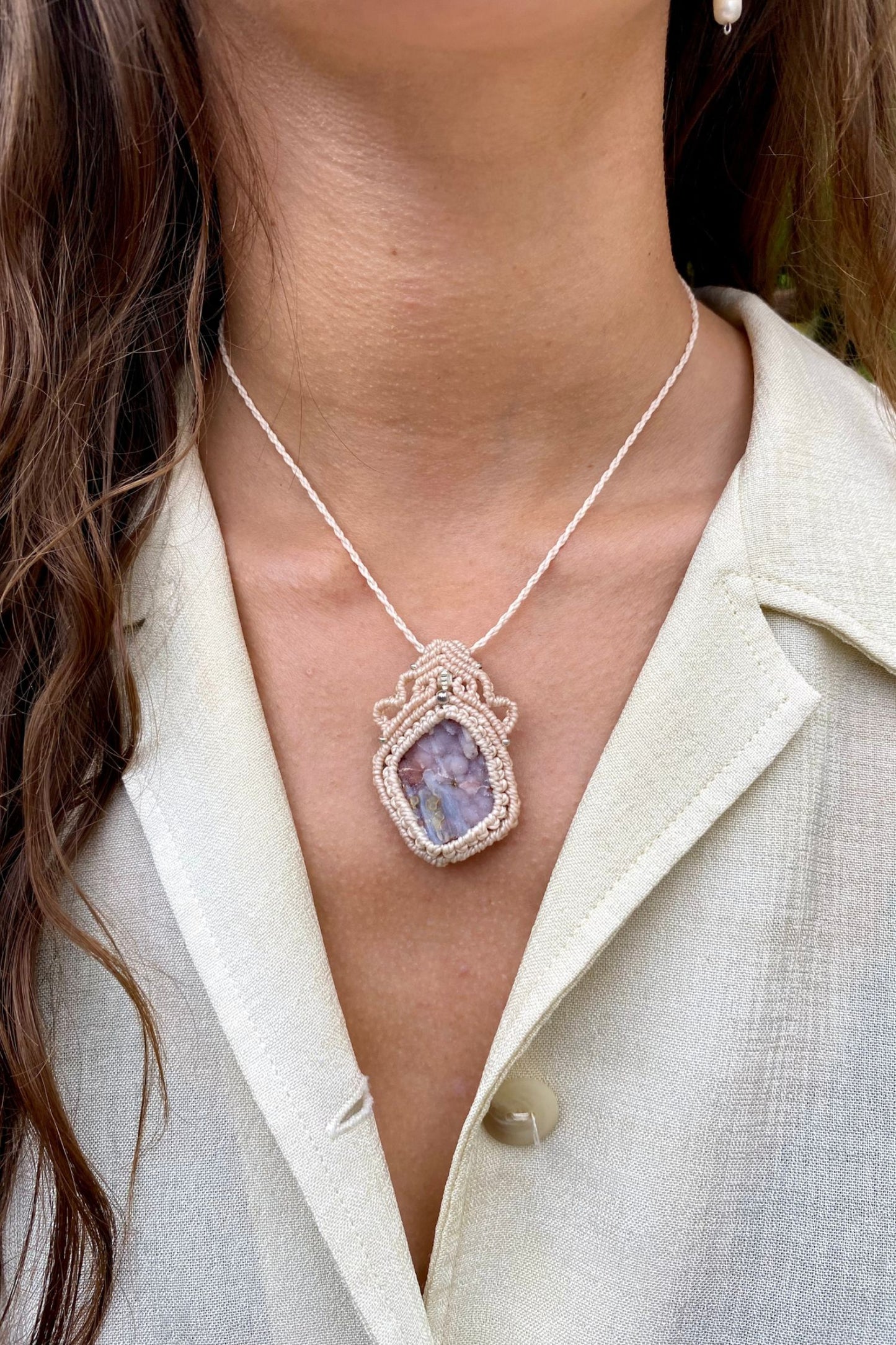 Handmade gemstone necklace worn, showing how the unique Raw Pink Chalcedony Stalactite pendant elegantly rests on the neckline.