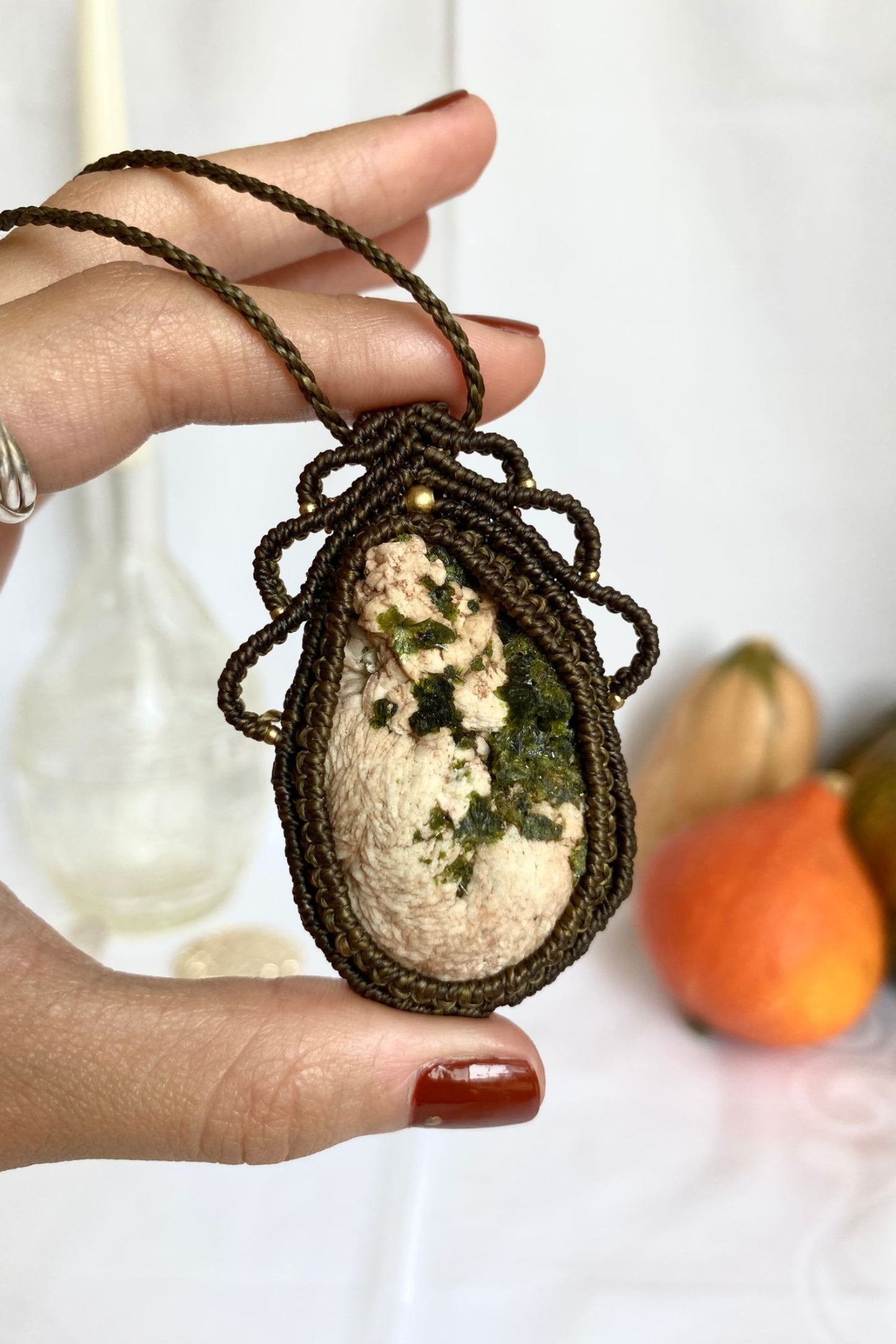 Detailed view of the handmade necklace, highlighting the raw textures of natural Prehnite and Epidote gemstone in a distinctive, statement-making design.