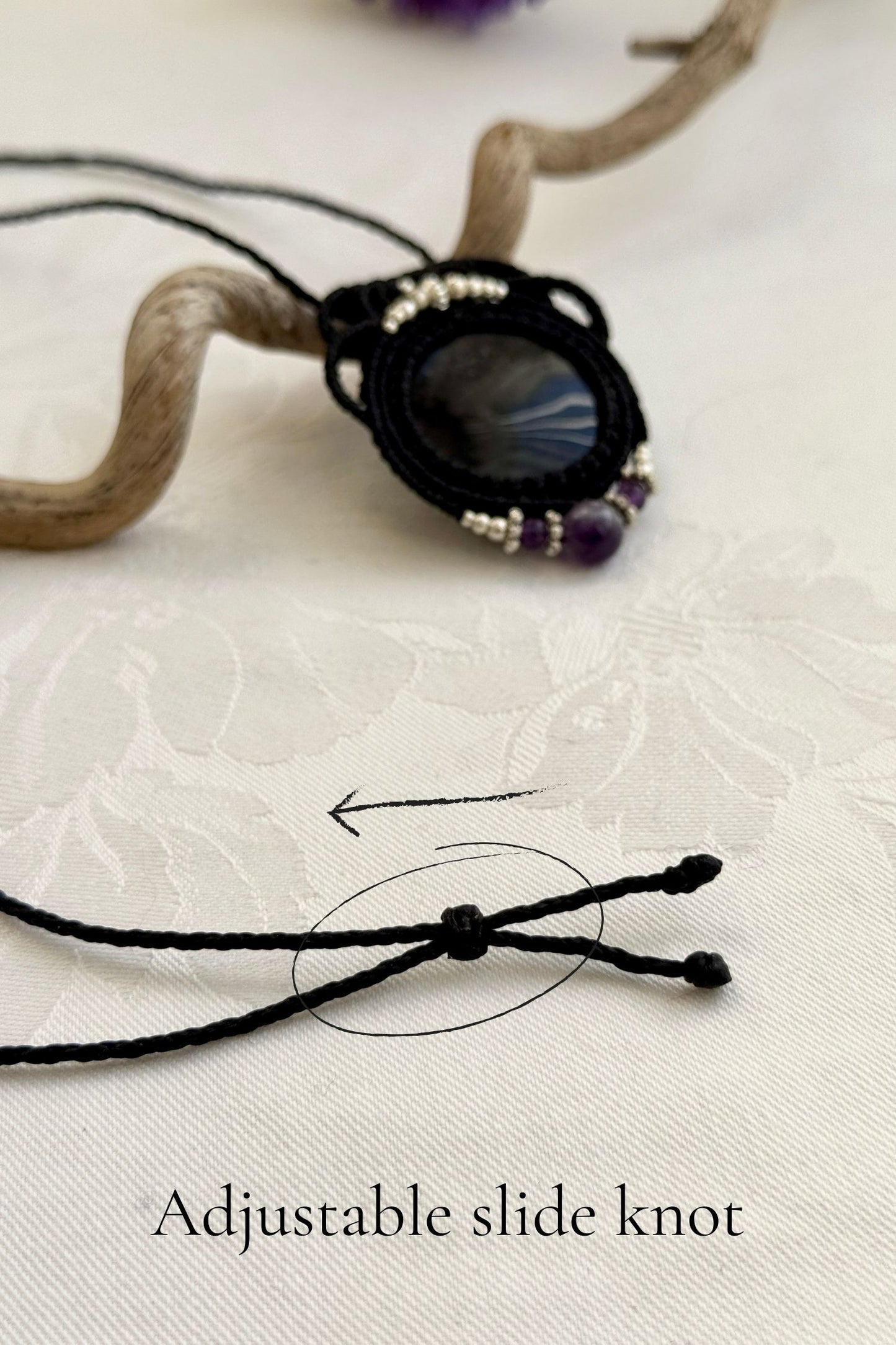Adjustable handmade macrame necklace with Silver Sheen Obsidian and Amethyst. Featuring a sliding knot closure for a customizable fit.