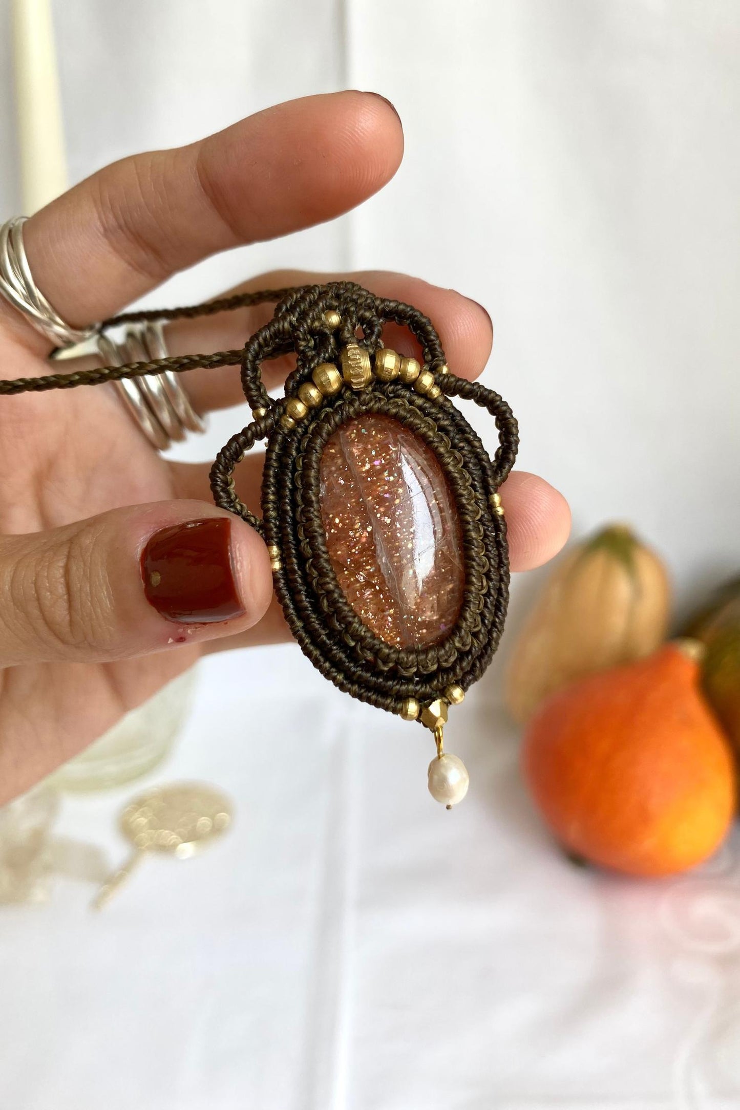 Detailed view of the handmade necklace, highlighting the raw textures of natural Sunstone gemstone and Pearl in a distinctive, statement-making design.