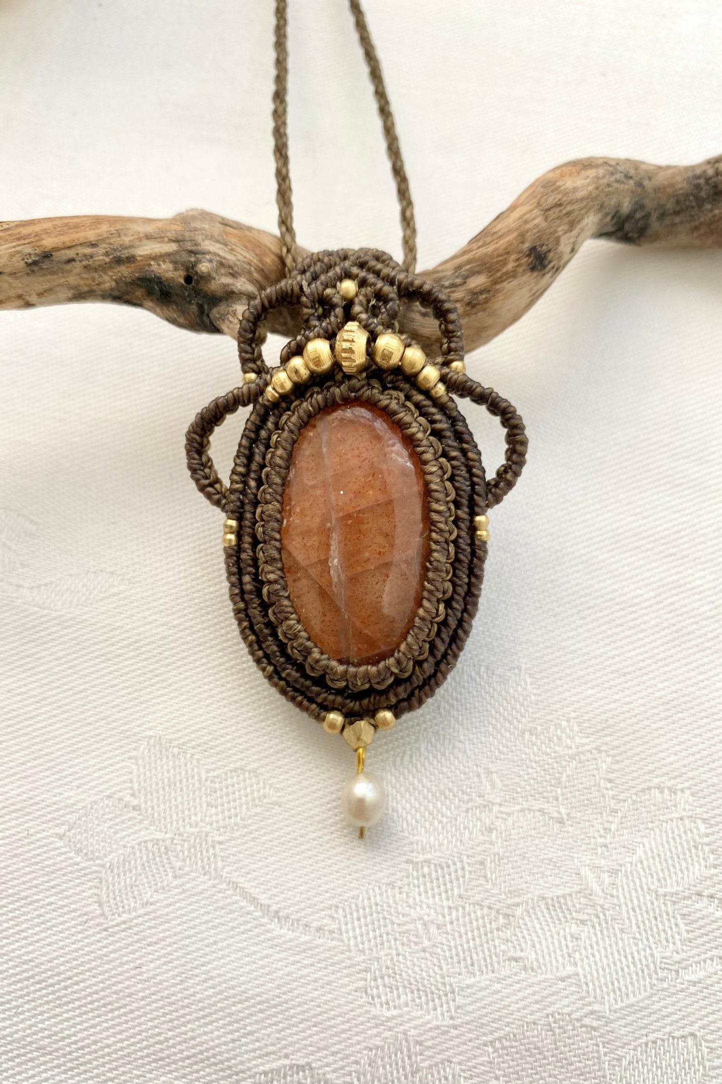 A close-up of the handmade gemstone necklace, showcasing the natural beauty of Sunstone and Pearl in an exclusive, one-of-a-kind design.