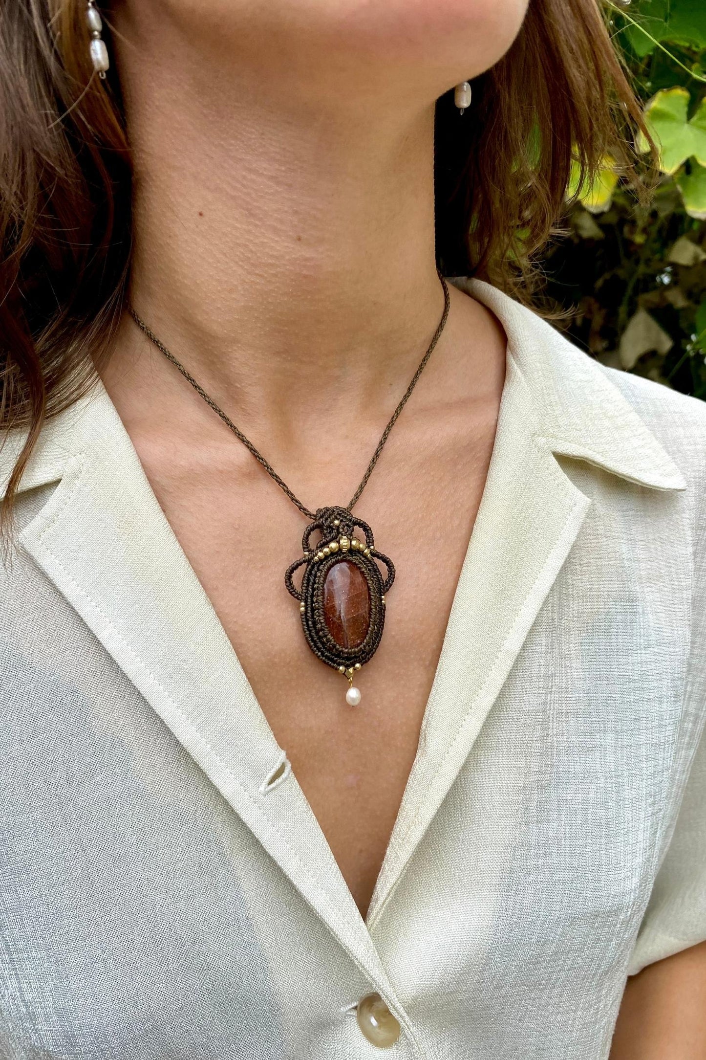 Handmade gemstone necklace worn, showing how the unique Sunstone and Pearl pendant elegantly rests on the neckline.