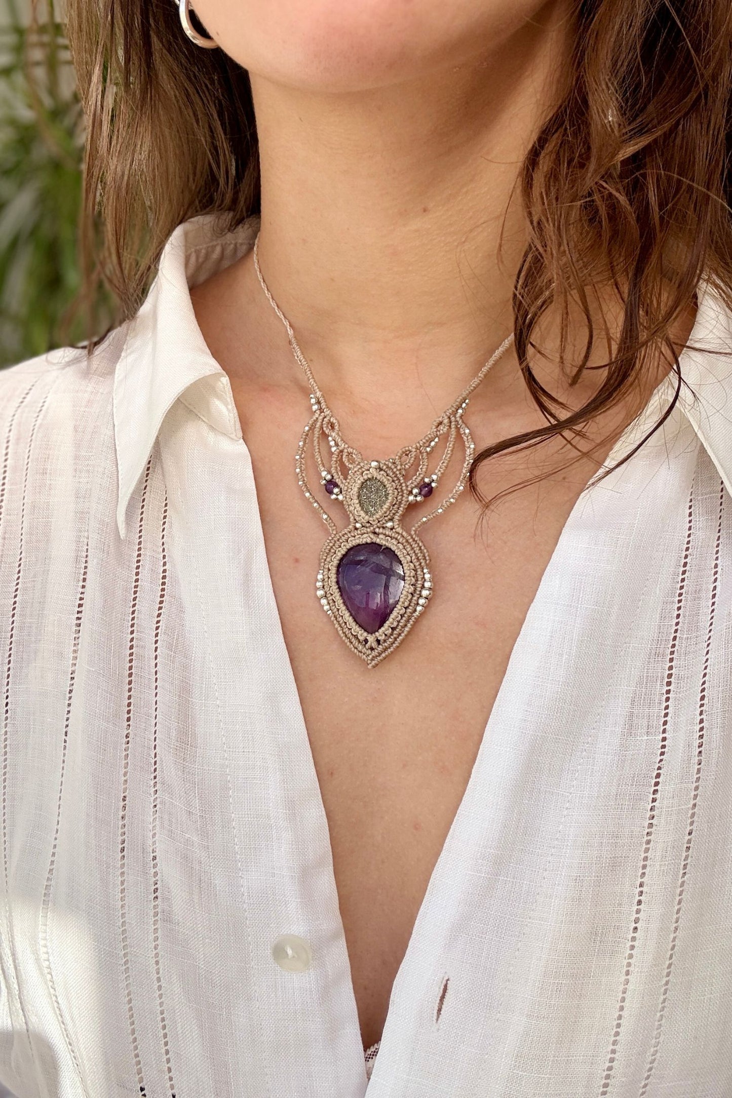 Amethyst and Druzy Pyrite macrame necklace worn by a model. Showcasing the unique handmade design and how it looks when worn.