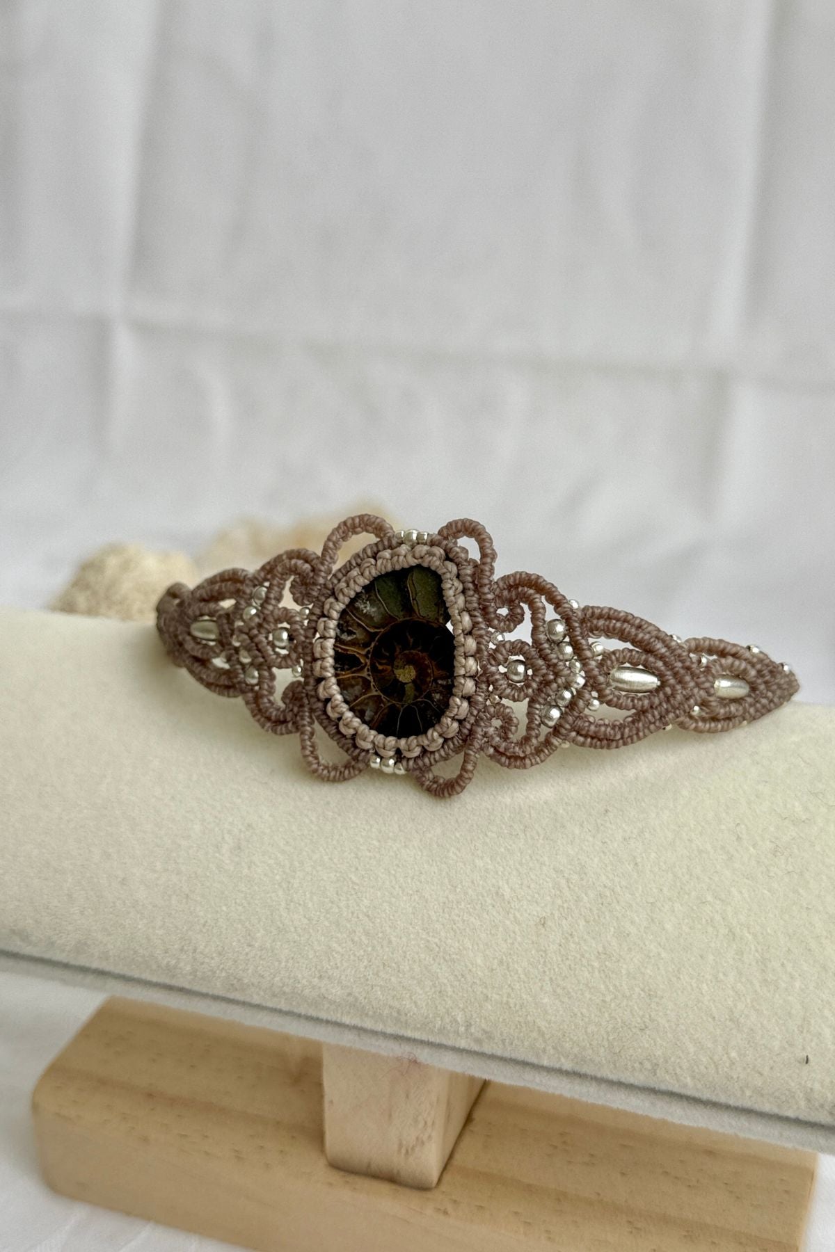 Side view of ammonite cuff bracelet showing sliced fossil texture and open cuff structure