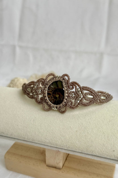 Side view of ammonite cuff bracelet showing sliced fossil texture and open cuff structure