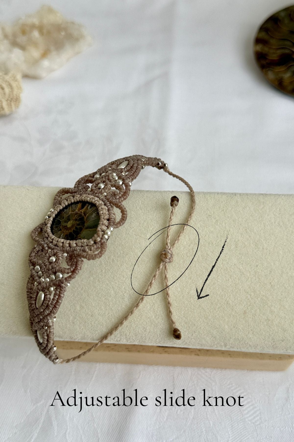 Adjustable slide knot detail of ammonite cuff bracelet, secure and comfortable artisan fastening