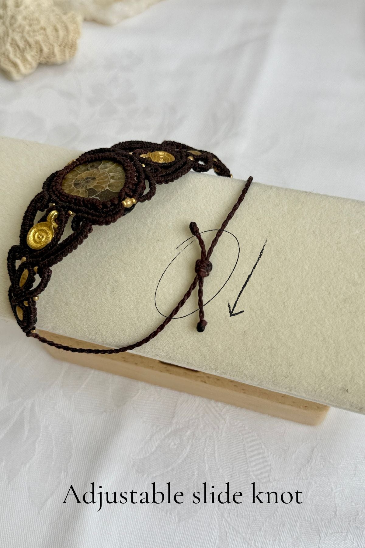 Adjustable slide knot detail of yellow ammonite cuff bracelet, secure and comfortable artisan fastening