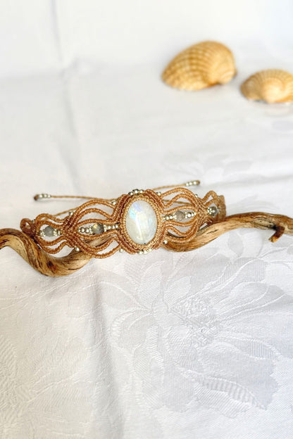 Angled view of the Moonstone and Labradorite bracelet, showing the oval centre stone and flowing macrame loops.