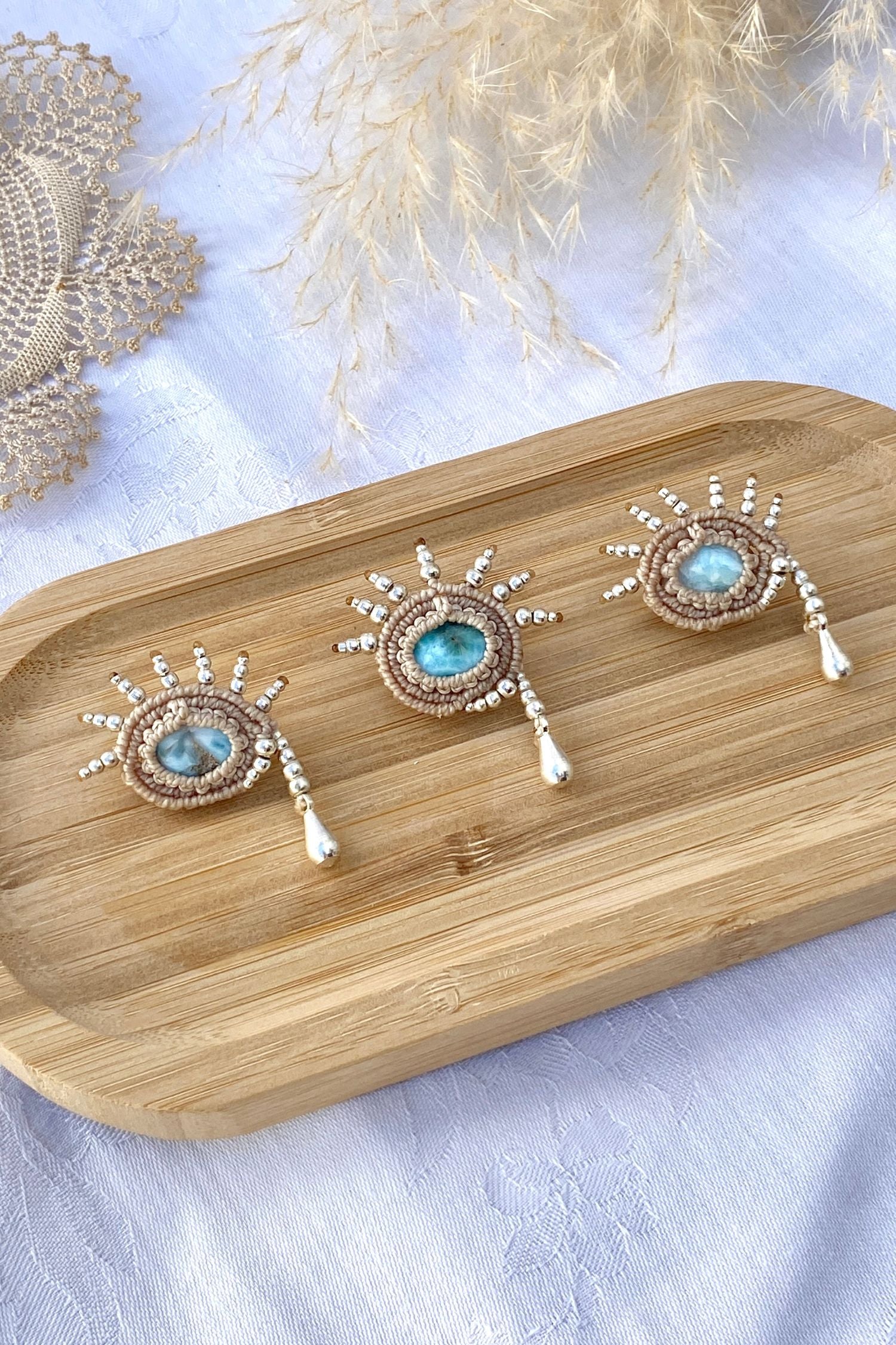 Side view of the handmade Larimar brooch, showcasing the three-dimensional silver bead details and unique teardrop-inspired shape.
