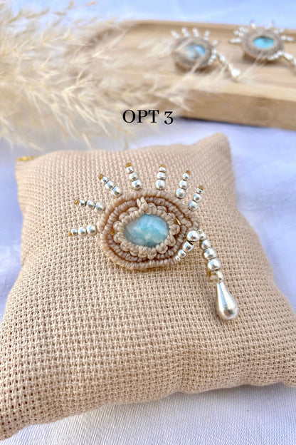 Close-up of the handmade brooch, highlighting the mesmerizing blue hues of the Larimar gemstone and the intricate silver teardrop beadwork.