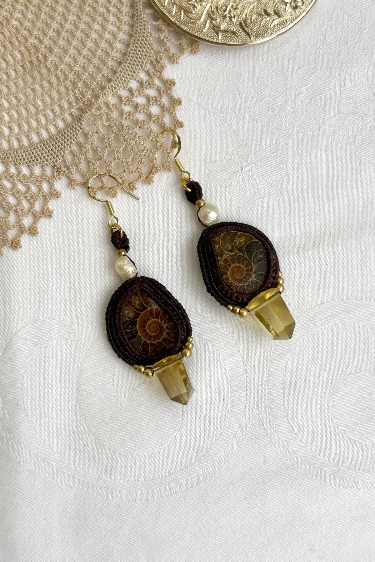 Unique sliced ammonite earrings with soft yellow smoky quartz points and pearl details, lightweight artisan jewelry