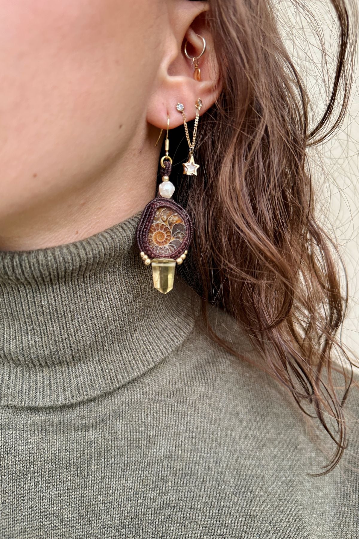 Model wearing sliced ammonite earrings with smoky quartz point and pearl accents, elegant one of a kind statement jewelry