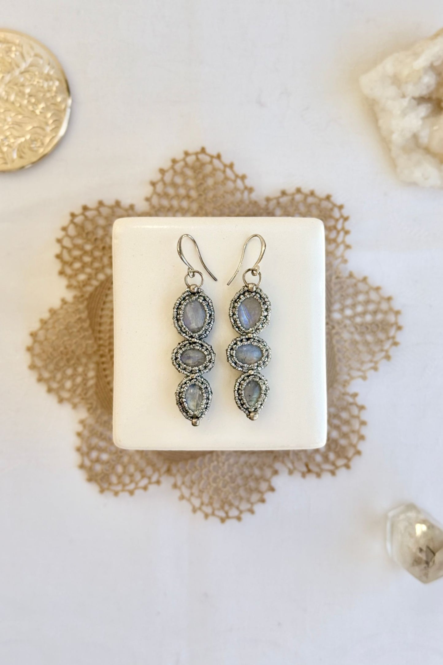 Handmade macrame earrings with Moonstone gemstones. One-of-a-kind design, laid flat for an artistic display.