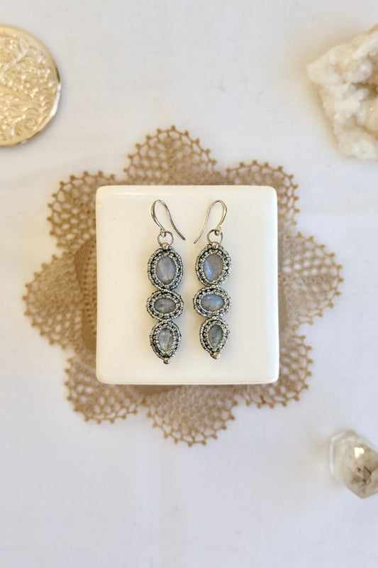 Handmade macrame earrings with Moonstone gemstones. One-of-a-kind design, laid flat for an artistic display.