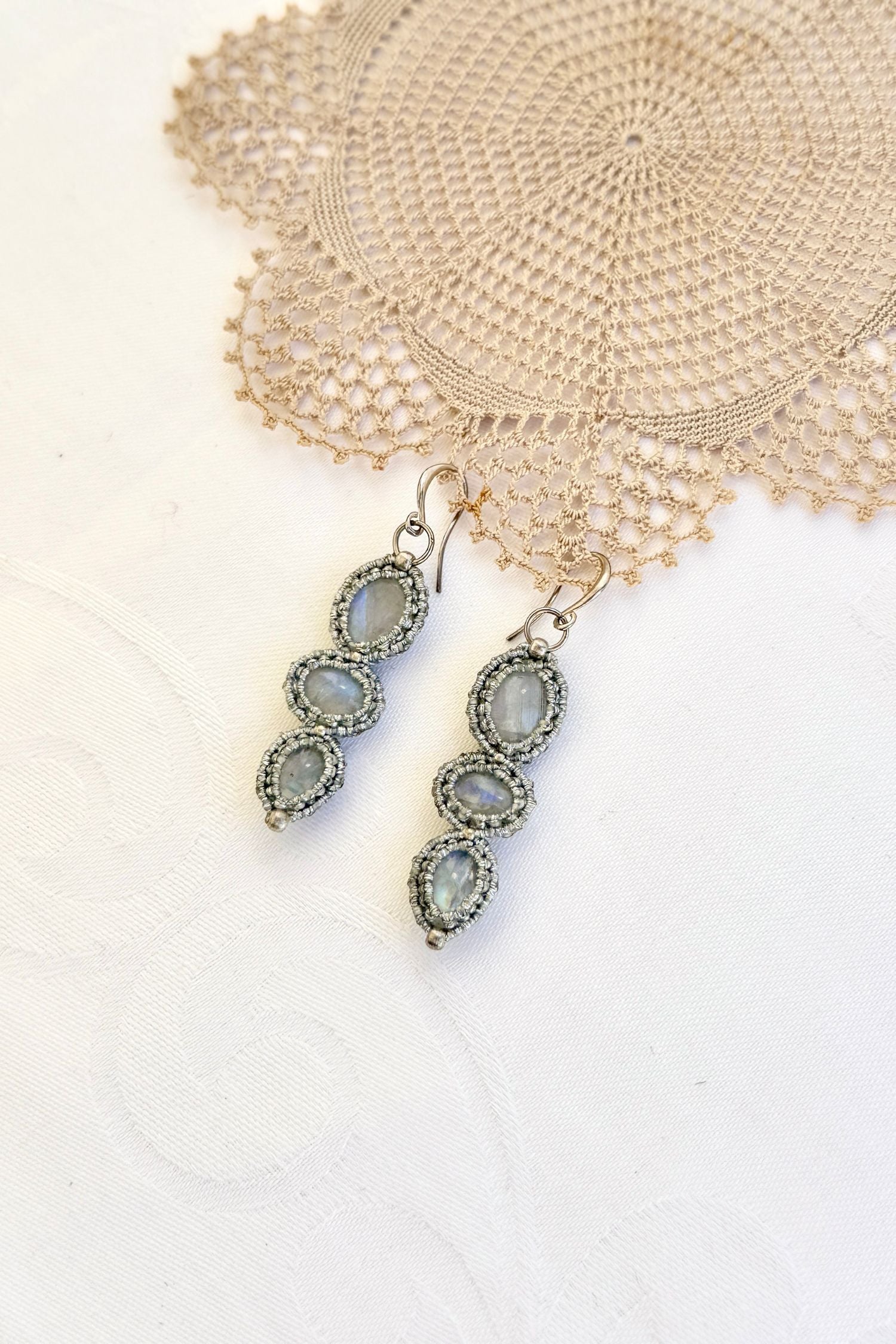 Close-up of the Moonstone macrame earrings in a unique setting. Highlighting the craftsmanship and gemstones details.