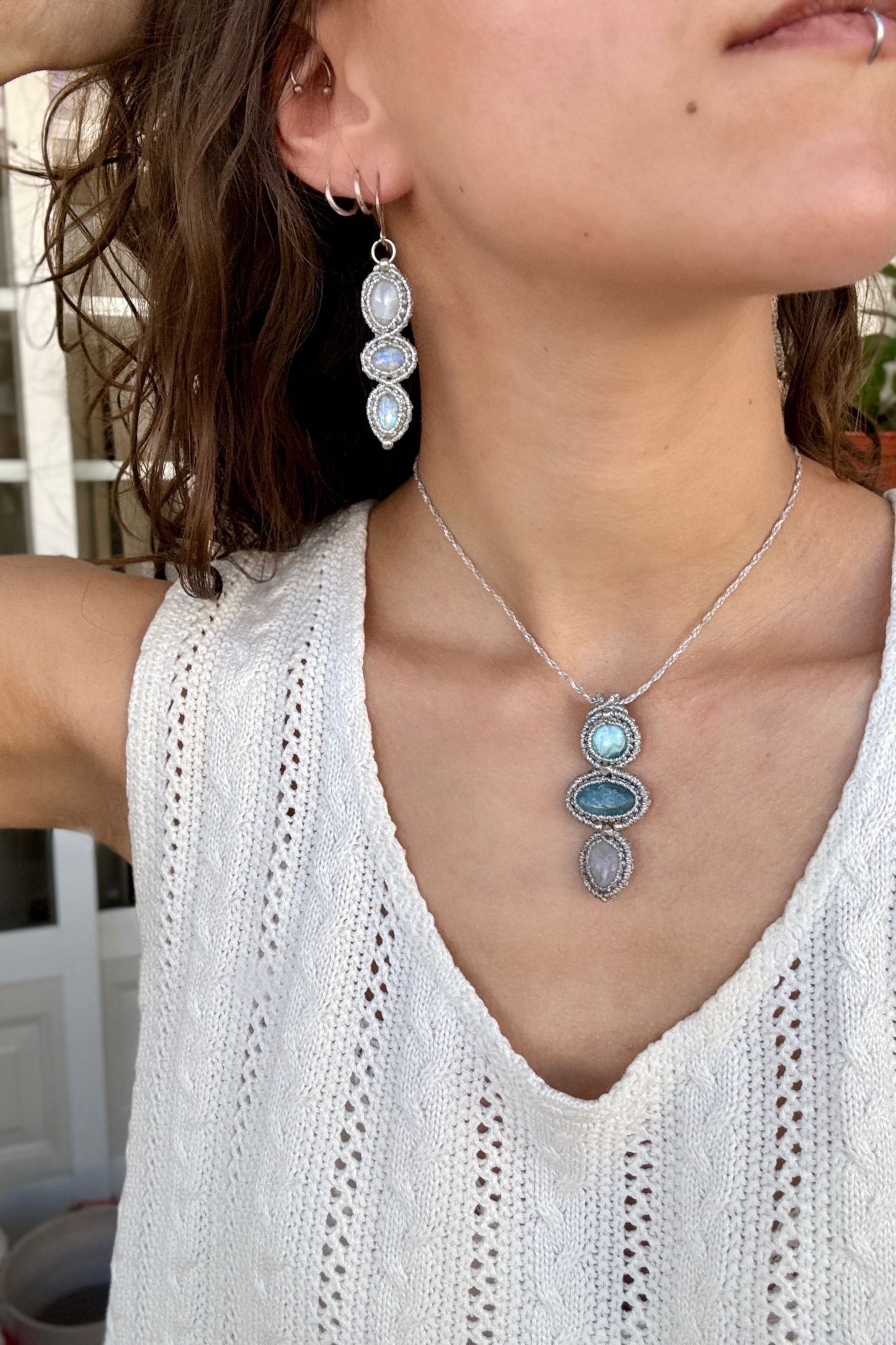 Moonstone  macrame earrings worn by a model. Showcasing the unique handmade design and how it looks when worn, lightweight and elegant.