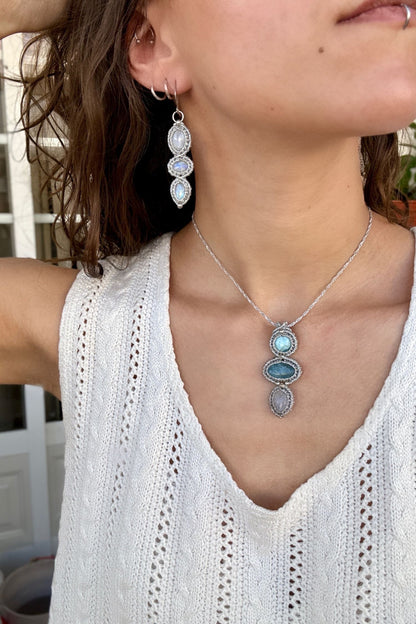 Moonstone  macrame earrings worn by a model. Showcasing the unique handmade design and how it looks when worn, lightweight and elegant.