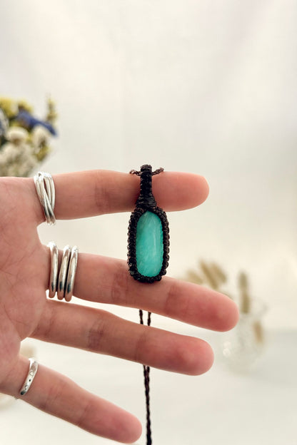 Handmade Amazonite macramé necklace held in hand, delicate natural gemstone jewelry