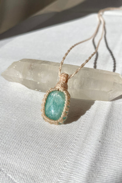 Close-up of handmade Amazonite Macrame necklace, showcasing the intricate macrame knotting and the vibrant blue hues of the gemstone.