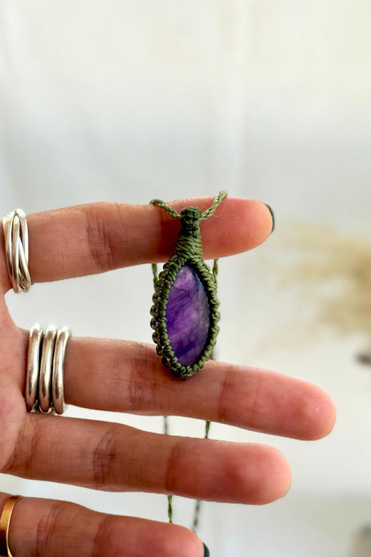 Hand holding a handmade Amethyst Macrame necklace from the Essence collection, featuring a high-quality gemstone in a delicate everyday-wear design.