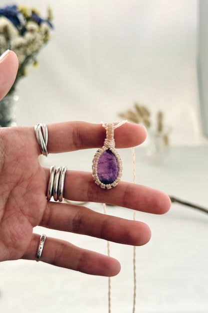 Handmade Amethyst macramé necklace held in hand, delicate natural gemstone jewelry