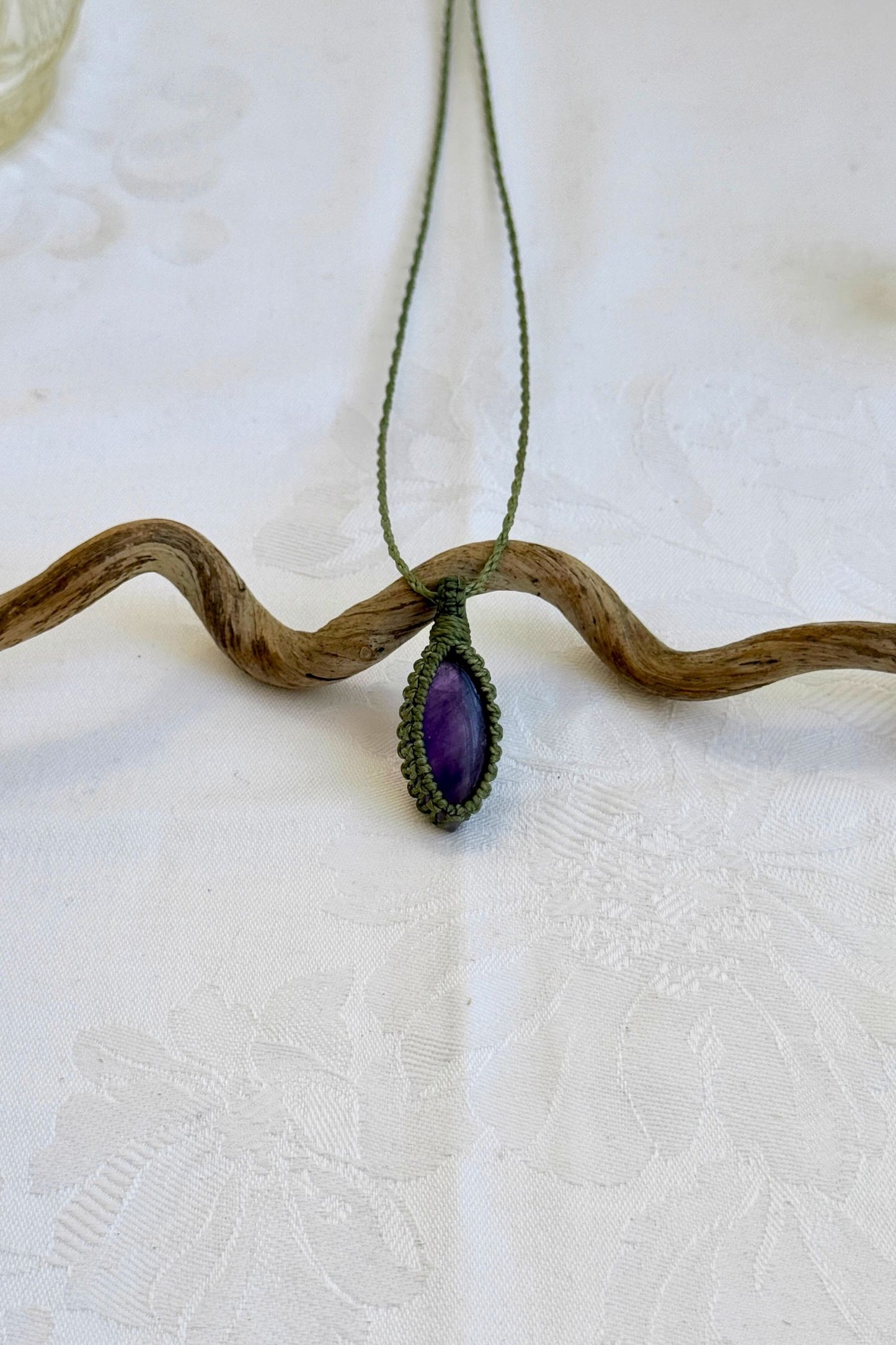 Handmade Amethyst Macrame necklace featuring a high-quality gemstone, laid flat to showcase its delicate everyday-wear design from the Essence collection.