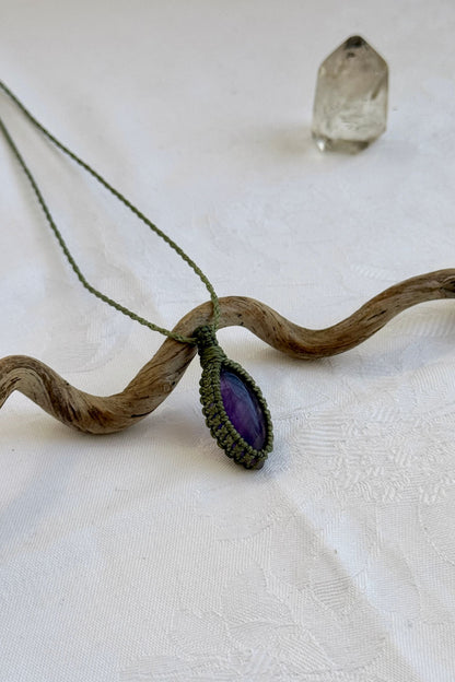 Another side angle shot of the handmade Amethyst Macrame necklace, emphasizing the elegant craftsmanship and natural gemstone colors.