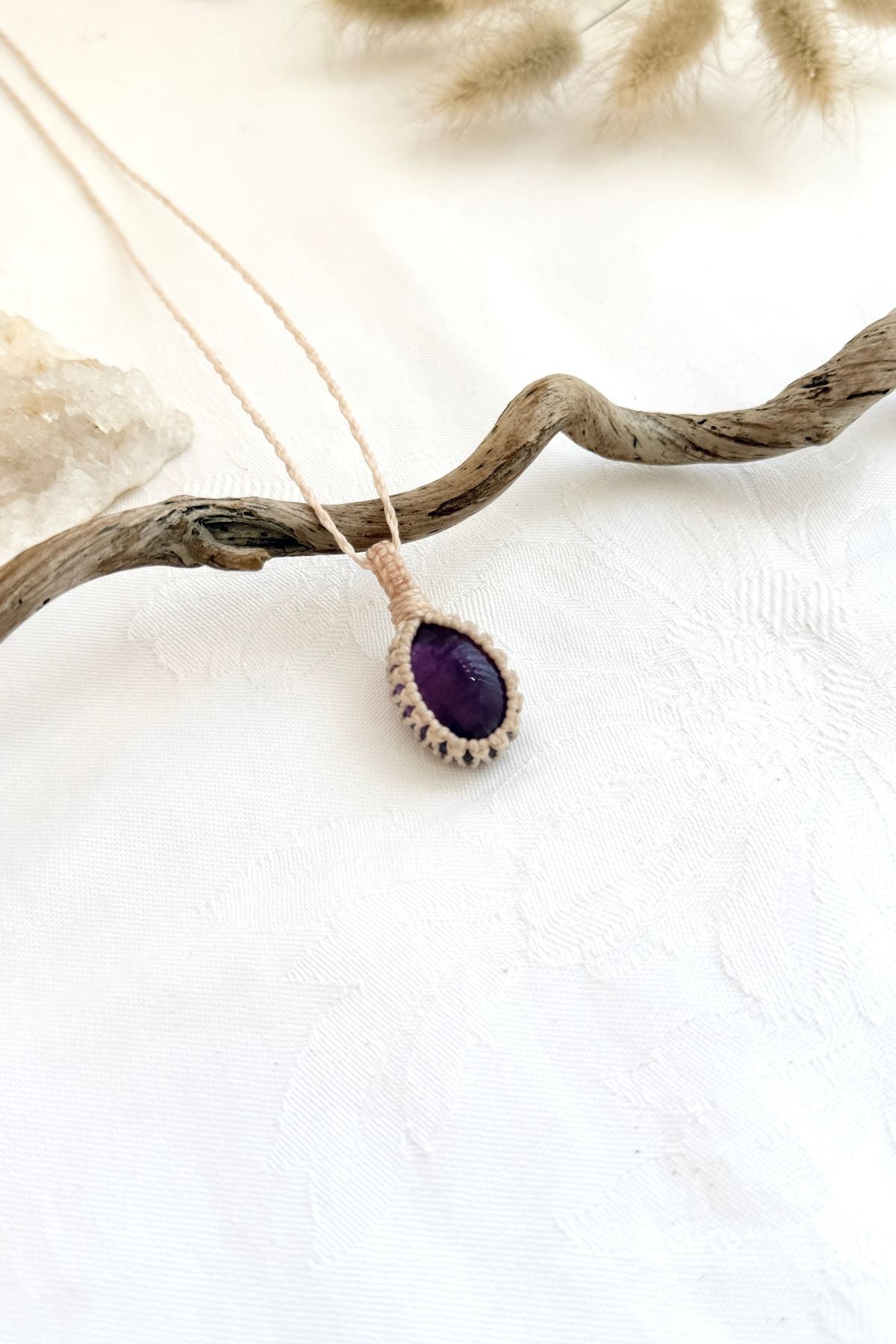 Handmade Amethyst macramé necklace, side view showing the gemstone and macramé knotting