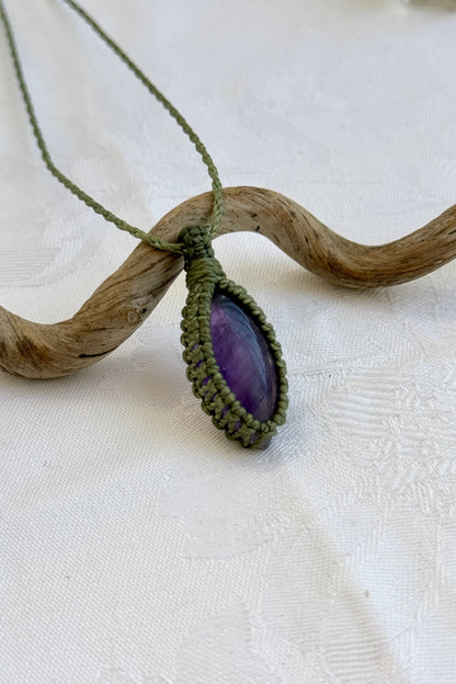 Close-up of handmade Amethyst Macrame necklace, showcasing the intricate macrame knotting and the vibrant patterns of the gemstone.