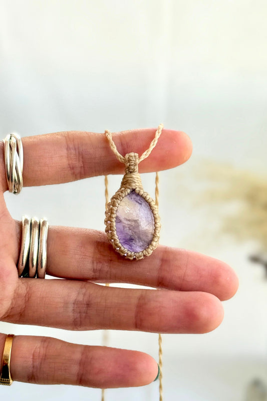 Hand holding a handmade Ametrine Macrame necklace from the Essence collection, featuring a high-quality gemstone in a delicate everyday-wear design.