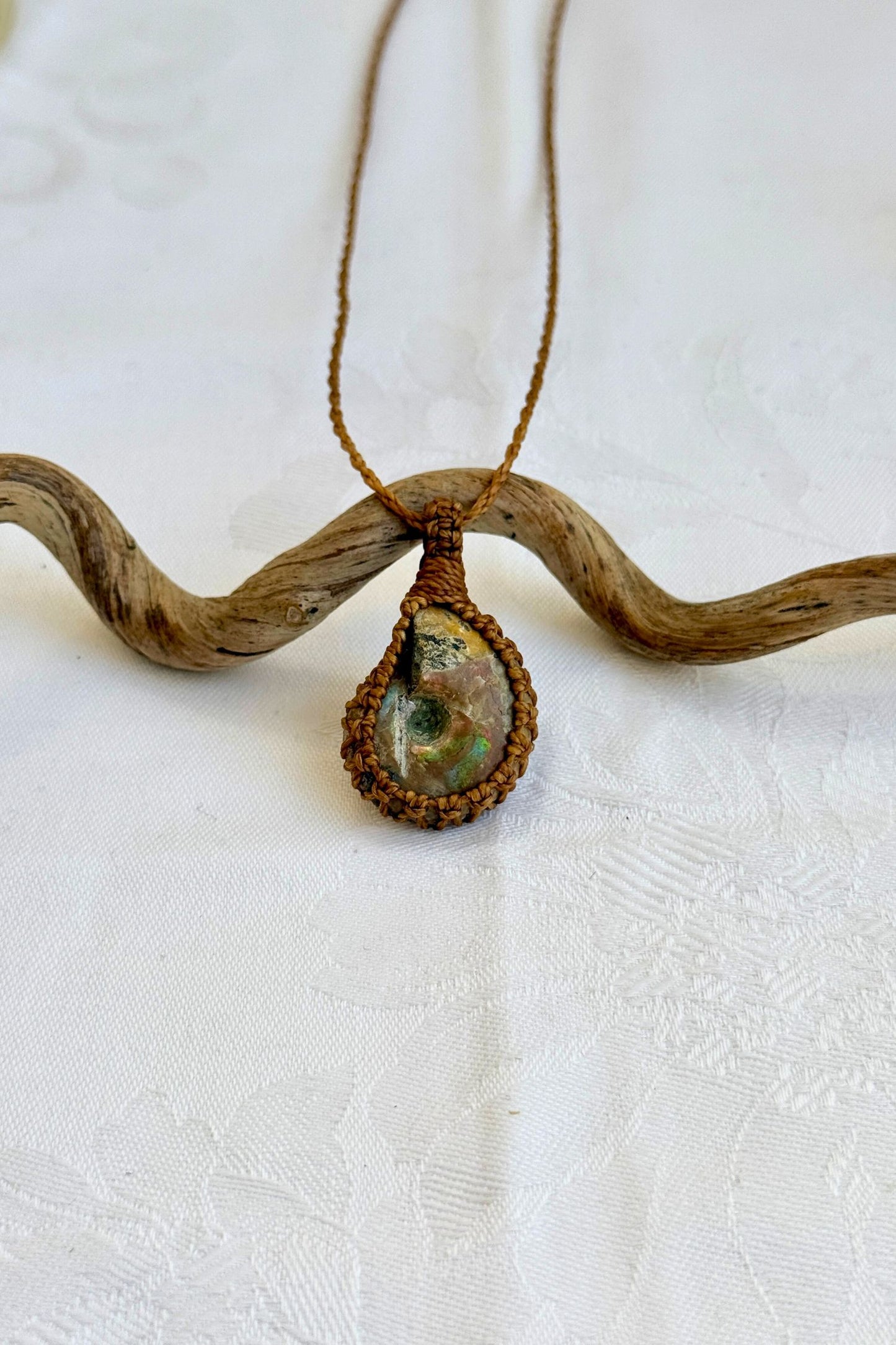 Handmade Ammonite Macrame necklace featuring a high-quality gemstone, laid flat to showcase its delicate everyday-wear design from the Essence collection.