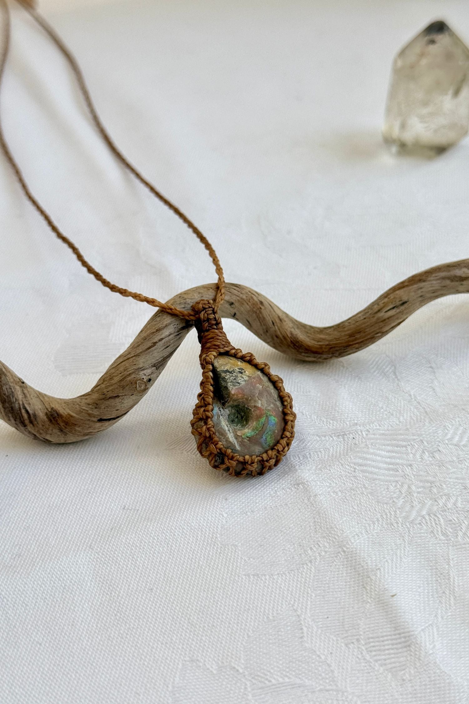 Another side angle shot of the handmade Ammonite Macrame necklace, emphasizing the elegant craftsmanship and natural gemstone colors.