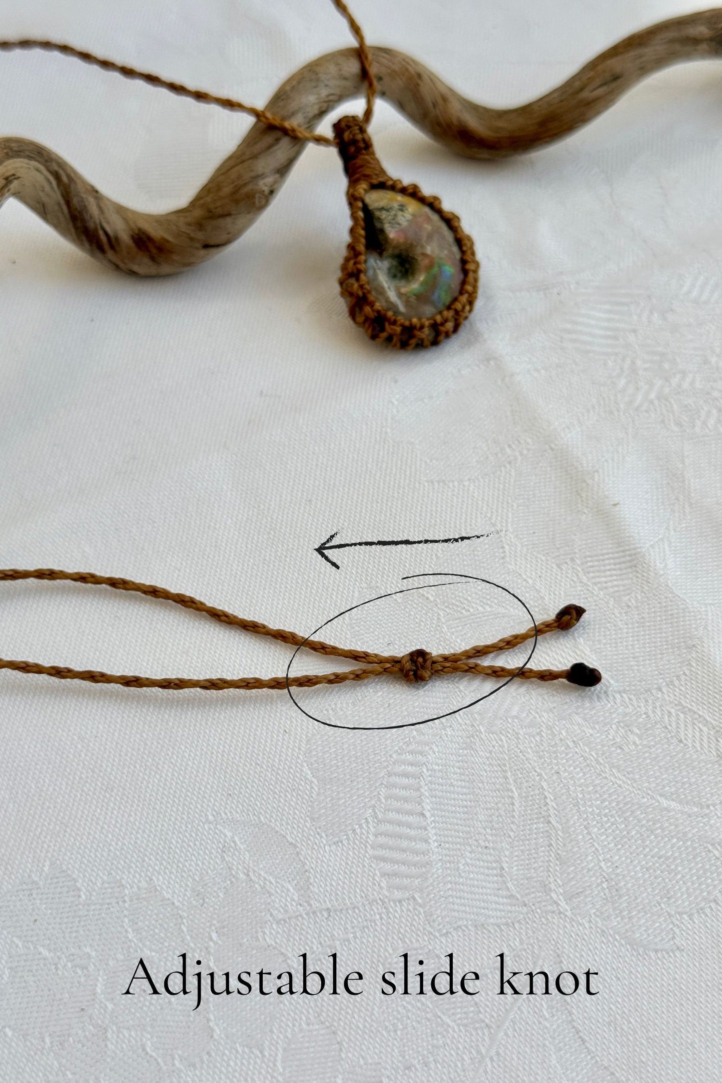 Close-up of the adjustable sliding knot on the Ammonite Macrame necklace, allowing for an easy and customizable fit for any wearer.