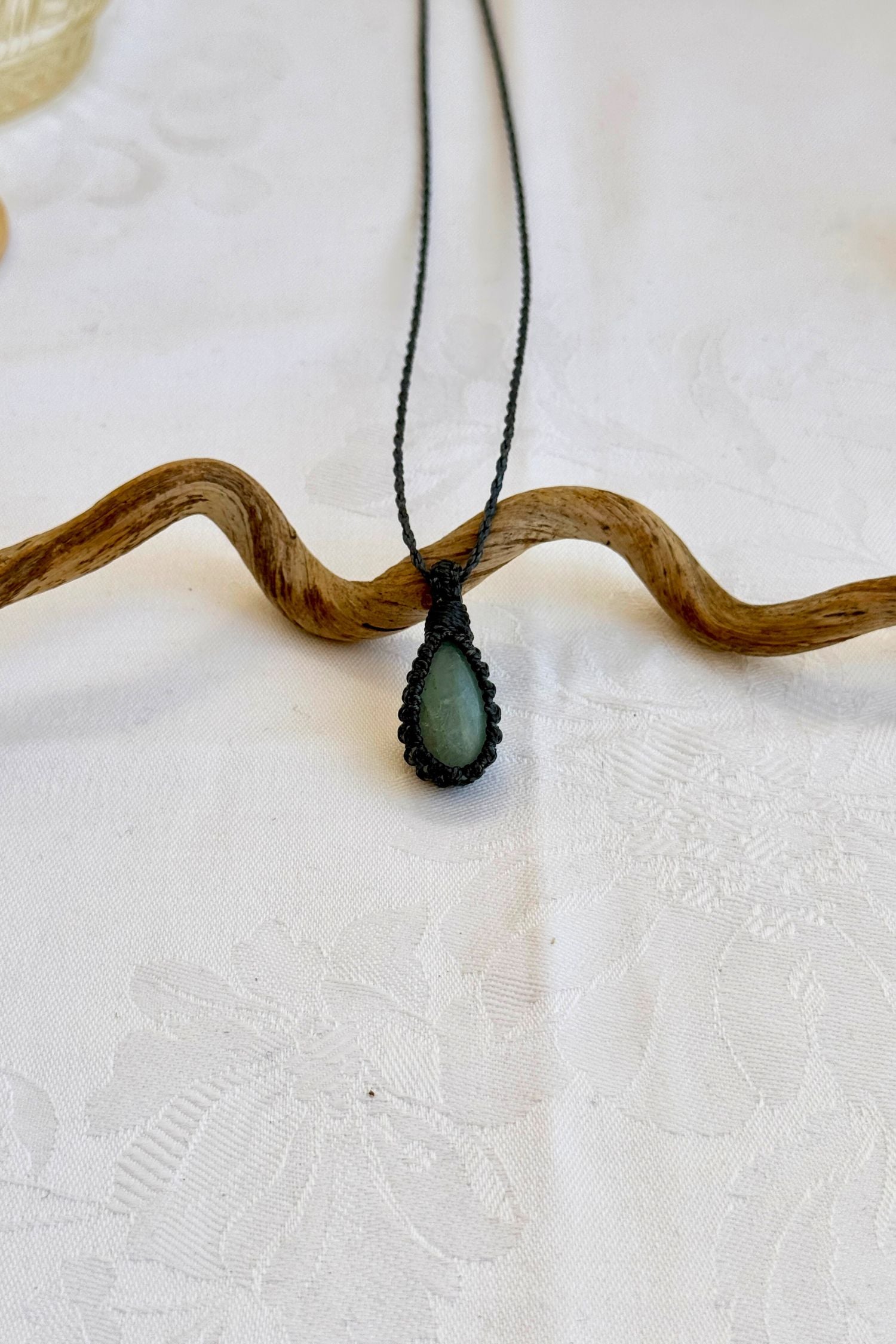 Handmade Aquamarine Macrame necklace featuring a high-quality gemstone, laid flat to showcase its delicate everyday-wear design from the Essence collection.