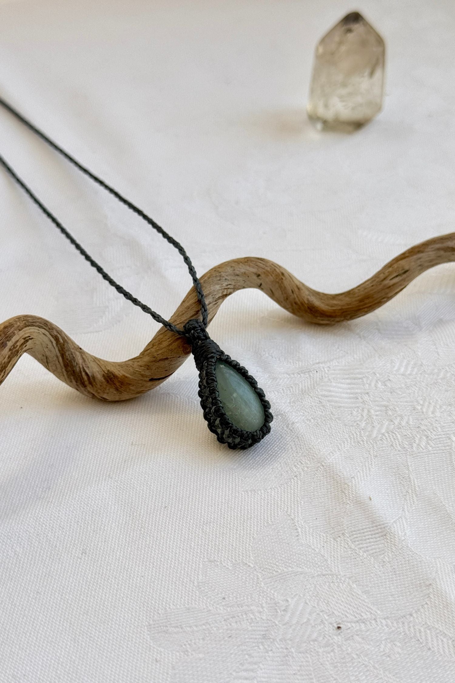 Another side angle shot of the handmade Aquamarine Macrame necklace, emphasizing the elegant craftsmanship and natural gemstone colors.