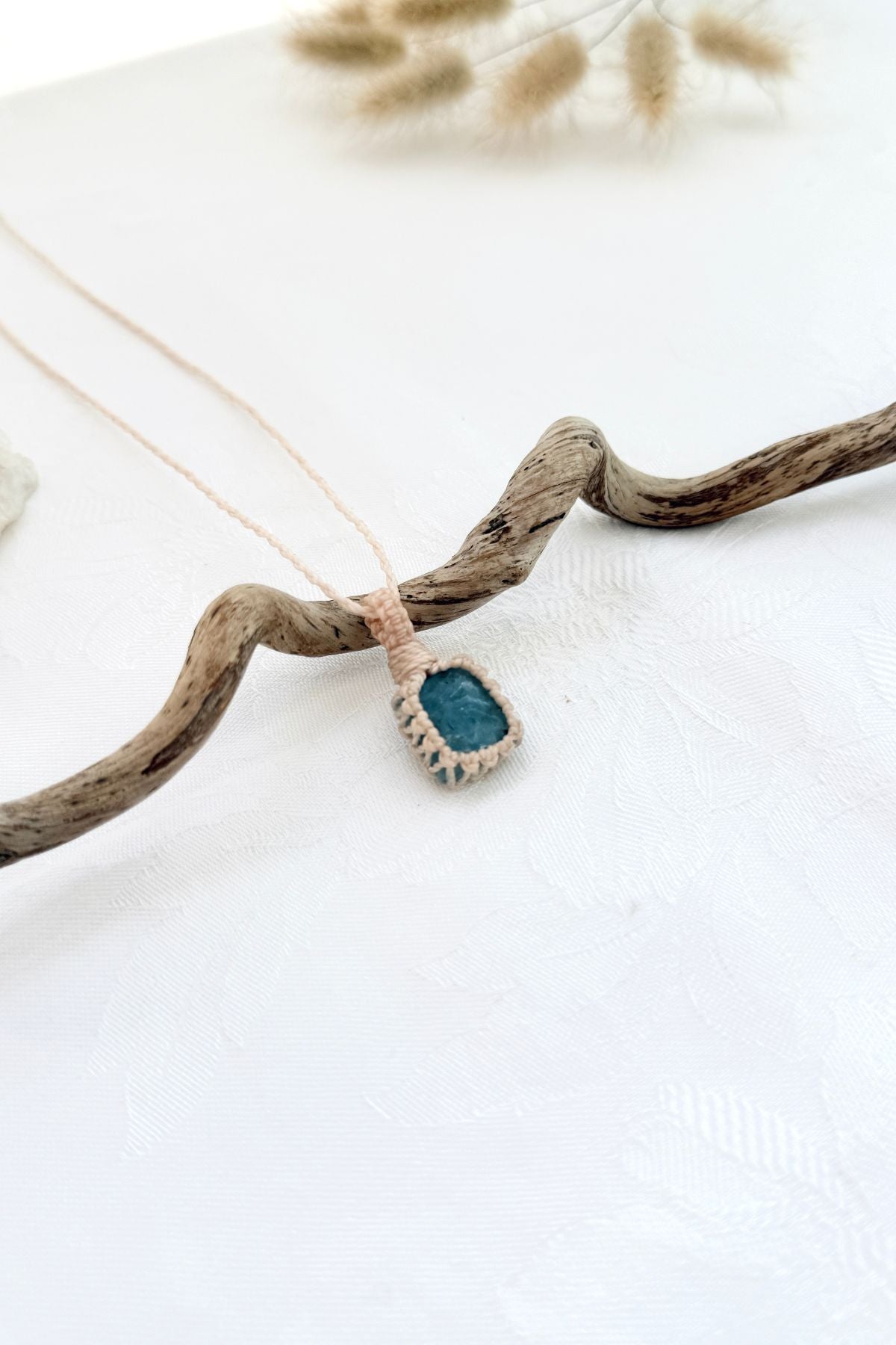 Handmade Aquamarine macramé necklace, side view showing the gemstone and macramé knotting