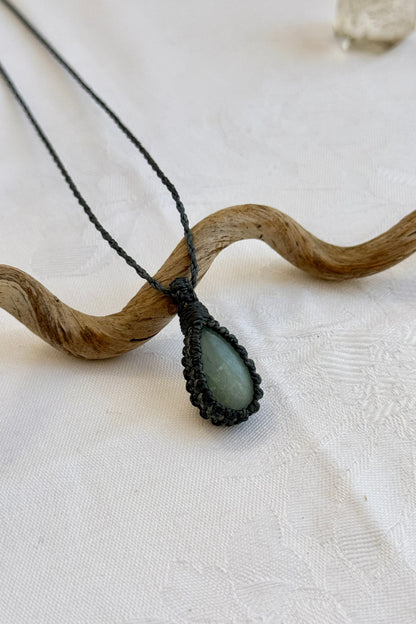 Close-up of handmade Aquamarine Macrame necklace, showcasing the intricate macrame knotting and the vibrant patterns of the gemstone.