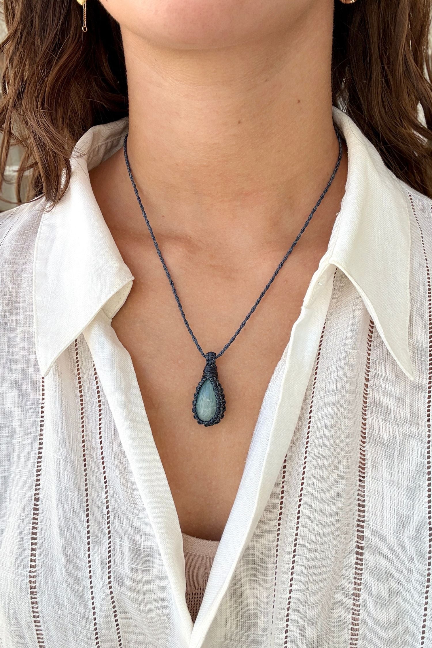 Model wearing a delicate handmade Aquamarine macrame necklace with a naivy blue cord, perfect for everyday wear.