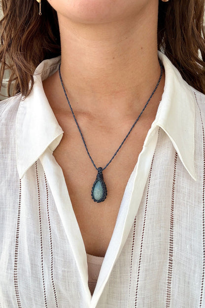Model wearing a delicate handmade Aquamarine macrame necklace with a naivy blue cord, perfect for everyday wear.