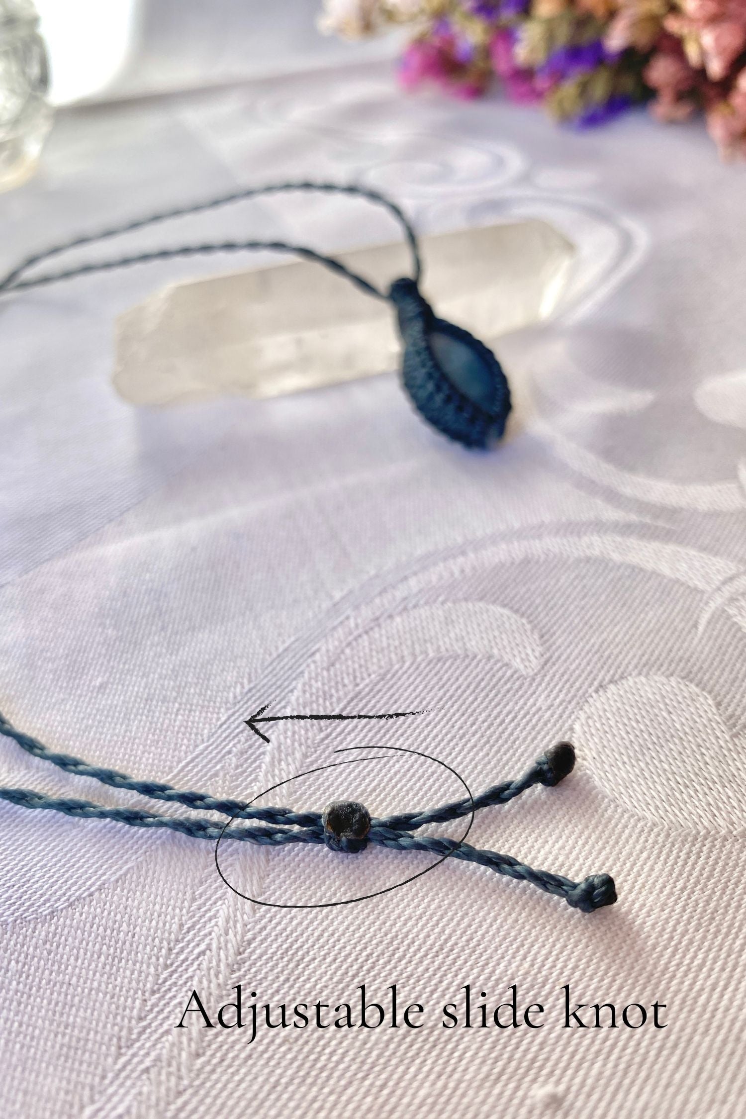 Close-up of the adjustable sliding knot on the Aquamarine Macrame necklace, allowing for an easy and customizable fit for any wearer.