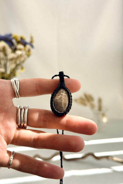 Handmade Black Moonstone macramé necklace held in hand, delicate natural gemstone jewelry