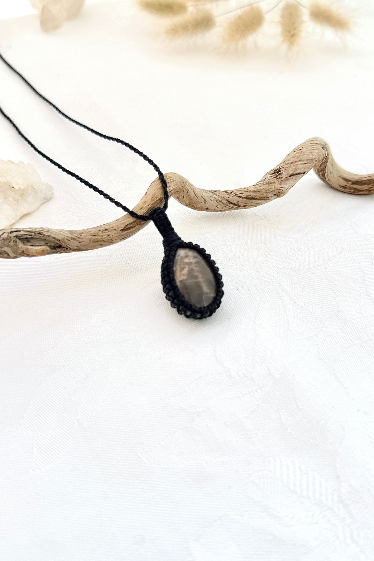Handmade Black Moonstone macramé necklace, side view showing the gemstone and macramé knotting