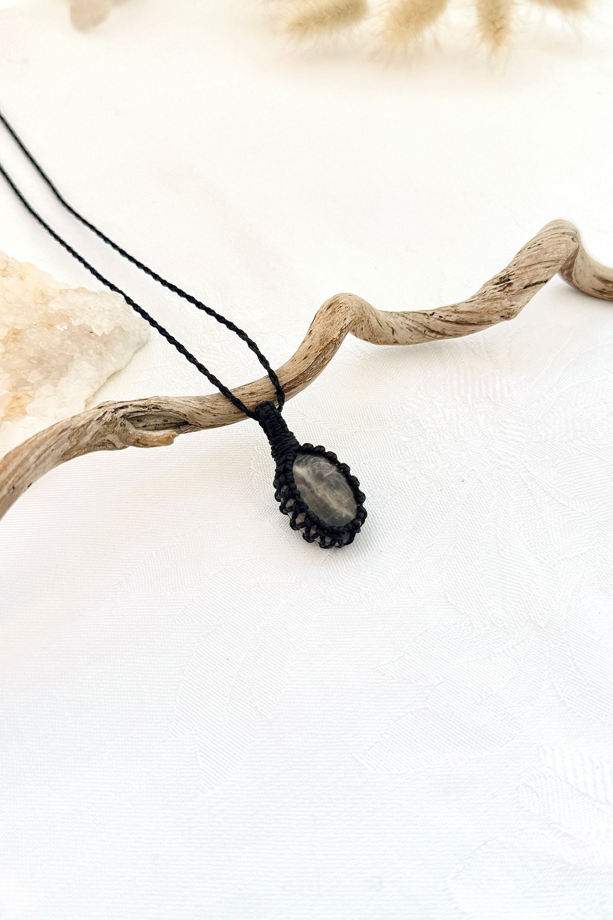Handmade Black Moonstone macramé necklace, side view showing the gemstone and macramé knotting
