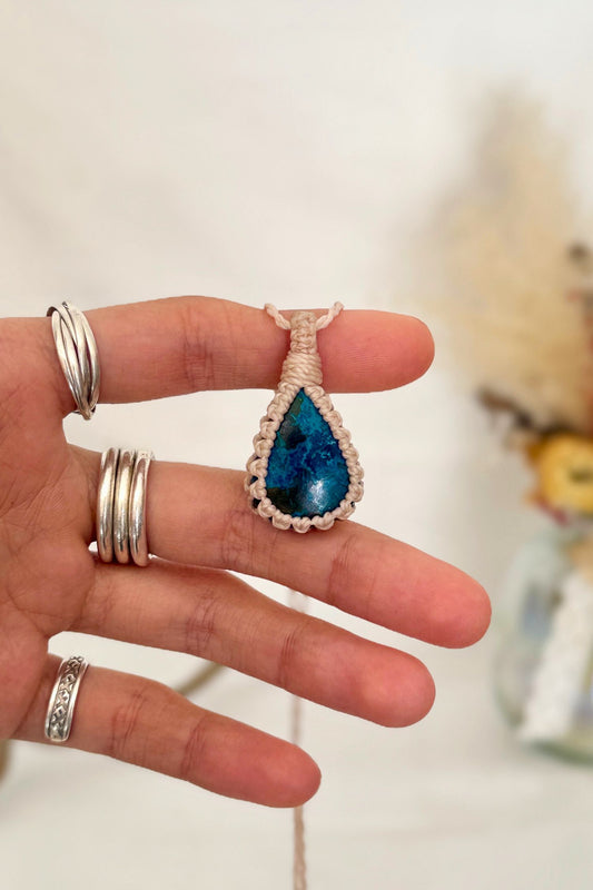 Hand holding a handmade Chrysocolla Macrame necklace from the Essence collection, featuring a high-quality gemstone in a delicate everyday-wear design.