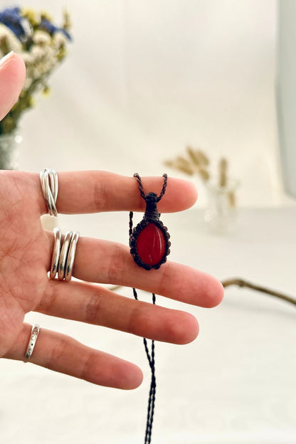 Handmade Carnelian macramé necklace held in hand, delicate natural gemstone jewelry