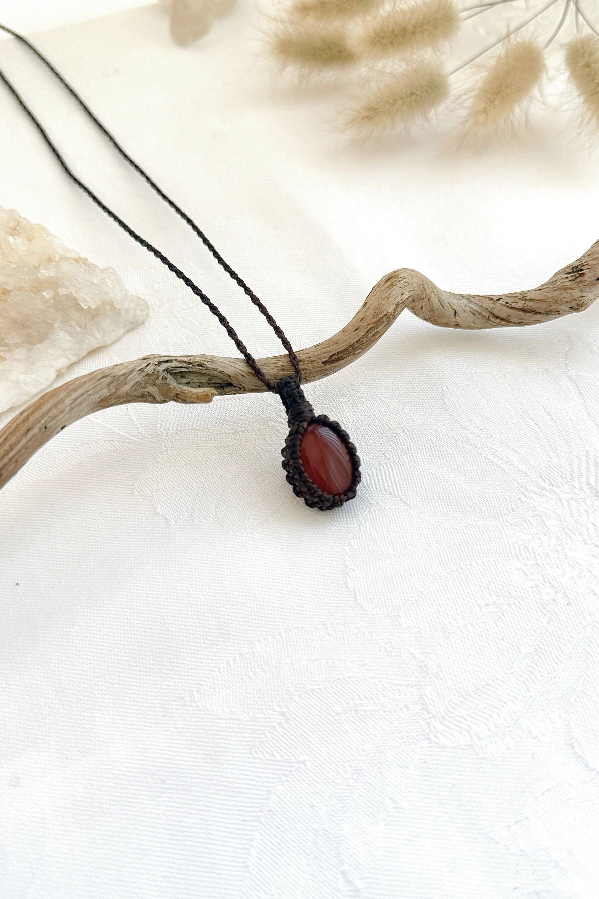 Handmade Carnelian macramé necklace, side view showing the gemstone and macramé knotting